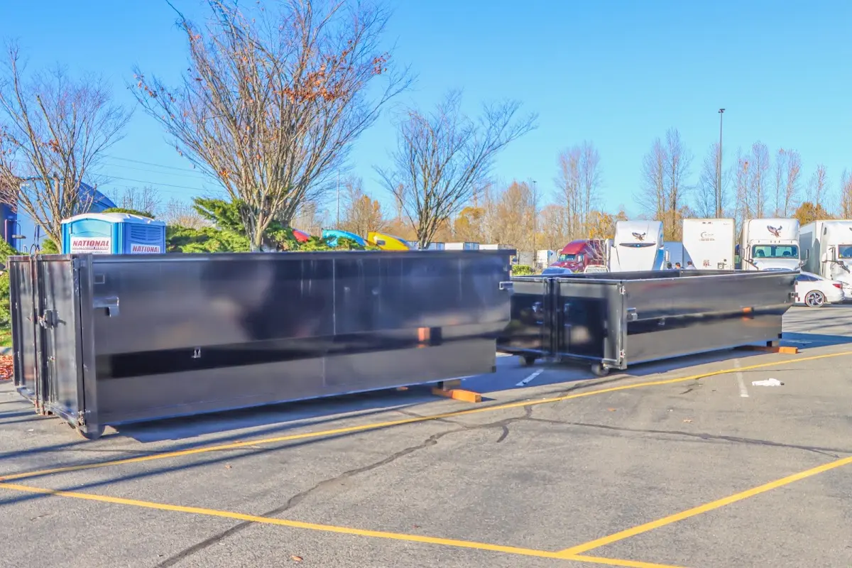 Professional dumpster rental service with roll-off container on residential driveway in North Middleton
